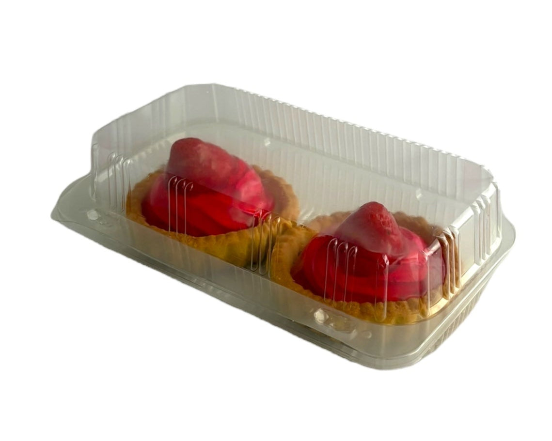 Two strawberry tarts in a clear plastic container on a white background